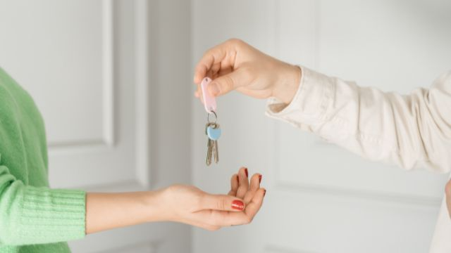 Key being handover to a woman for her first home